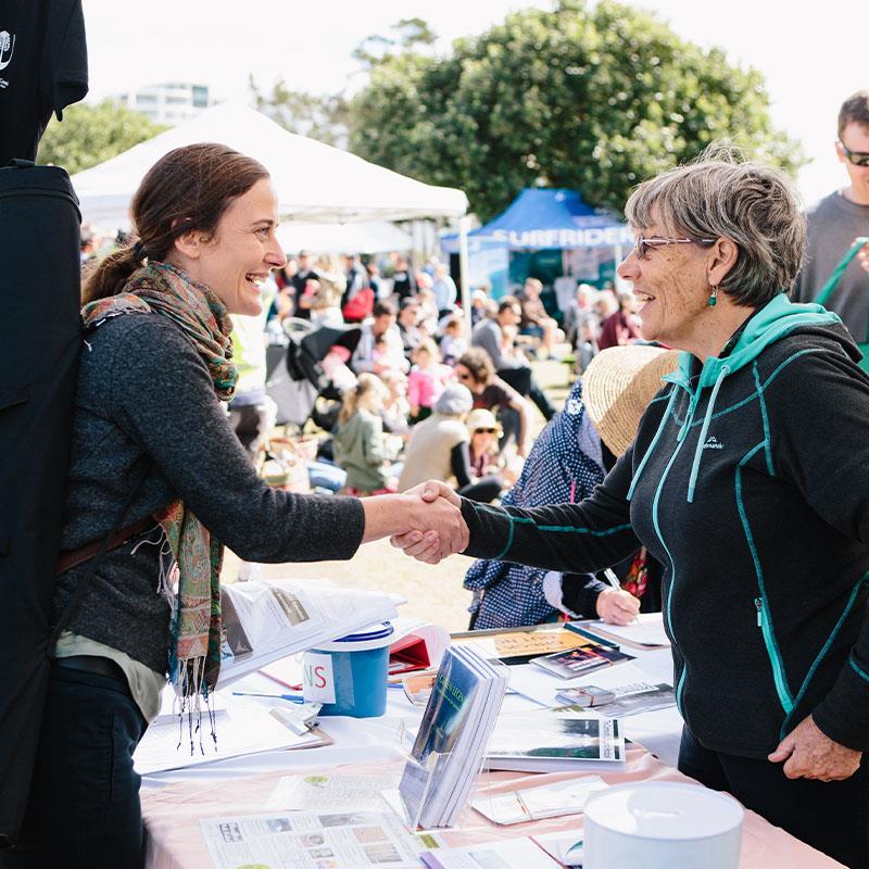Community shaking hands at environmental event