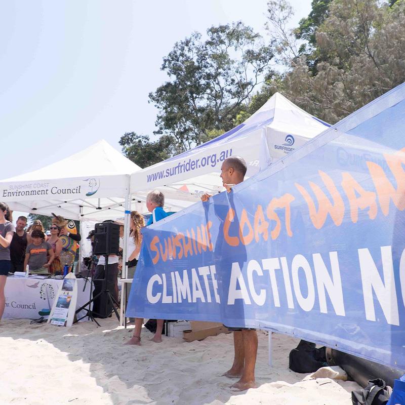 man holding banner about climate action
